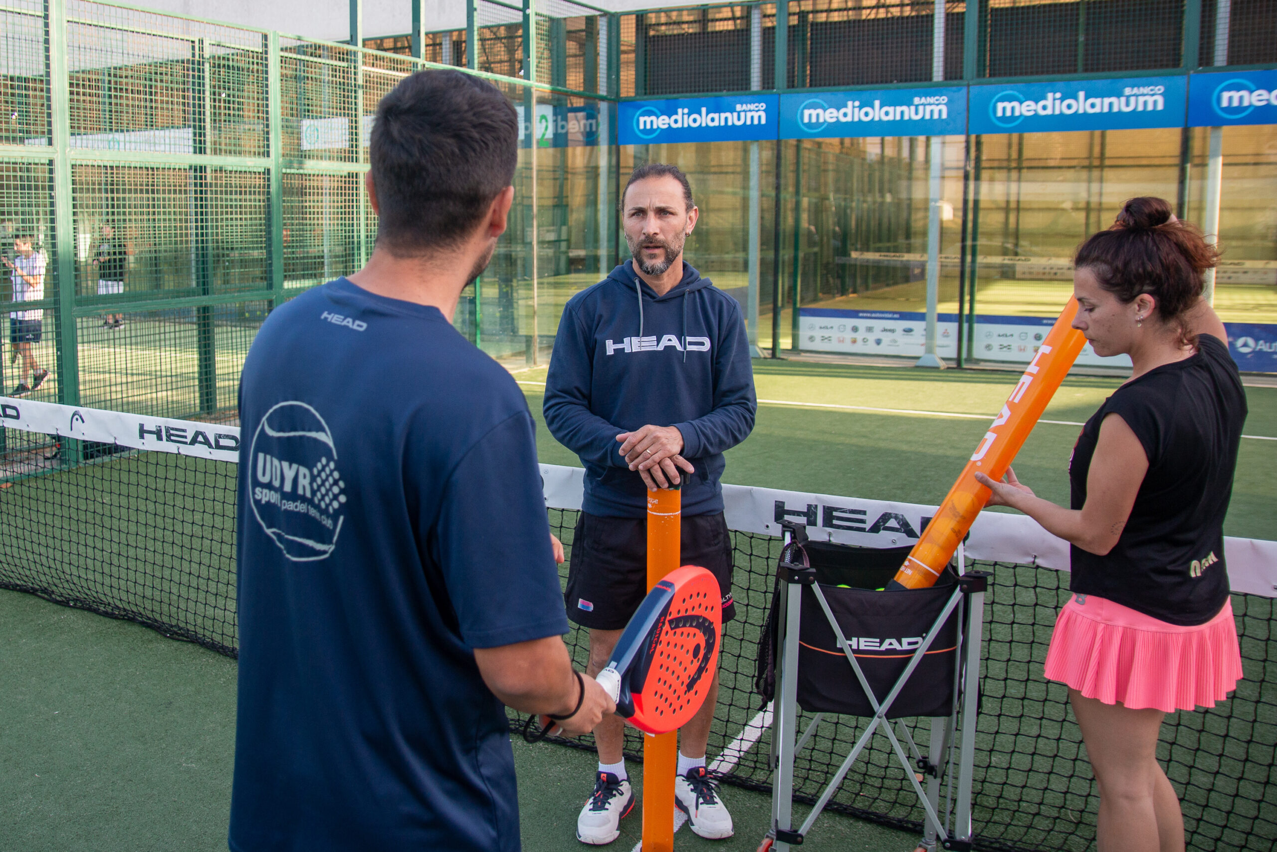 profesor teaching a man and a women training with him